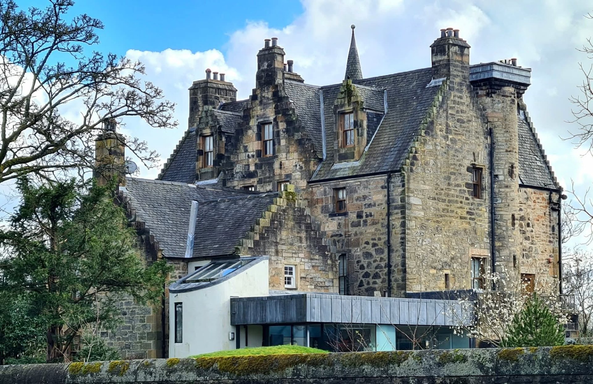 Slate roofs and turret work on a traditional Scottish stone property