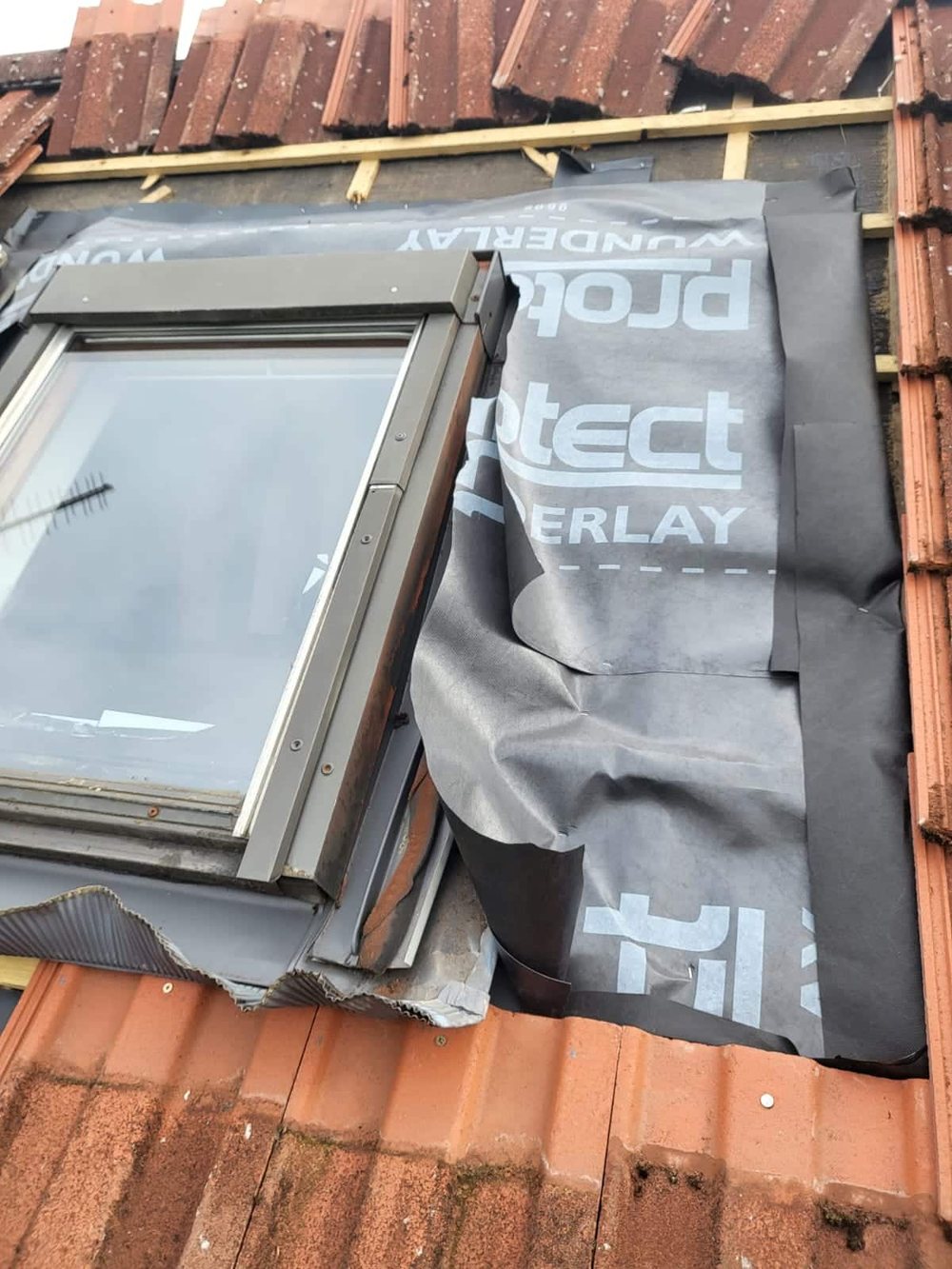 Roof window fitted and weathered into the slate